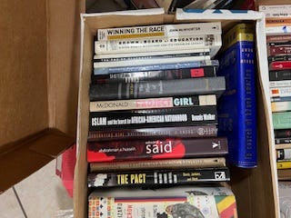 A selection of books in nine images. Each image has several books all lined up together in a row. One is a top-down look at four books that features their covers instead of their spines. Titles include:  W.E.B. Du Bois' "The Philadelphia Negro," "Between Past and Future" and "Human Condition" by Hannah Arendt, "Middle Passages: African American Journeys to Africa," 1787-2005," Michael Eric Dyson's "Holler If You Hear Me," and "City Schools and the American Dream: Reclaiming the Promise of Public Education" by Pedro A. Noguera and James A. Banks