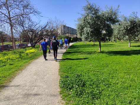 Participants on the route, plus a barren hard-packed surface under the playground