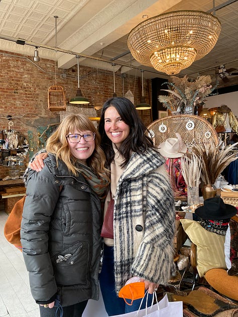 tina gill and lena piskorowski posing together with big smiles inside a boho boutique and a hotel room, various cards handwritten by tina to lena