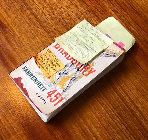 LEFT: Photo of post it notes on top of a copy of FAHRENHEIT 451. The first reads, "Is there a scene w/ Montag having an 'igniter'? Yes, page 13." The second note reads, "Important: virtually the entire story takes place at nighttime. The sun appears only at the end." CENTER: Photo of the book fanned with more post its on the back with quotes and page numbers. RIGHT: Photo of FAHRENHEIT 451 held open to the contents page. Handwritten notes fill both pages with page numbers and details from the text quoted.