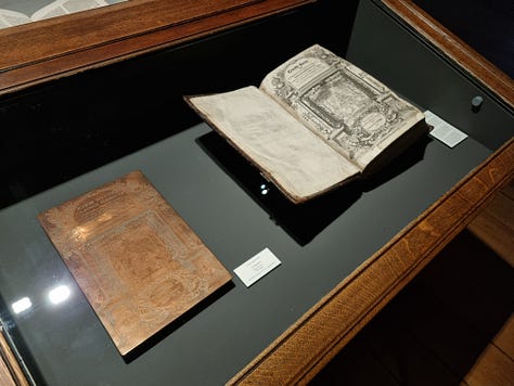 Photo 1: Aisling in the printing room, the printing presses are visible to the right. Photo 2: an image engraved on copper plate with the ink imprint of the image displayed in a book to the right. Photo 3: an imprint of a skeleton looking fed up. 