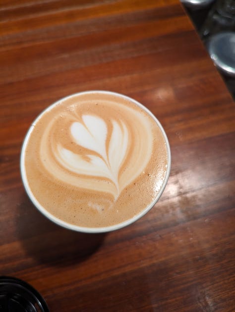 A gallery of pictures, of the menu, a wall design, latte art, and a coffee bag