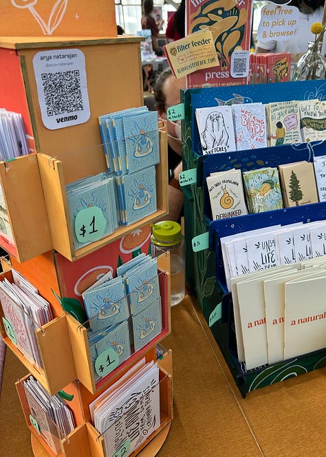 tall display stands full of illustrated zines of all sizes