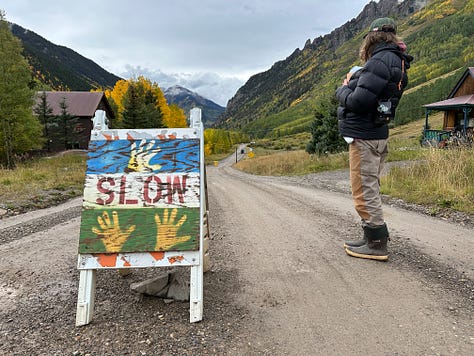 various handmade signs telling you to slow down