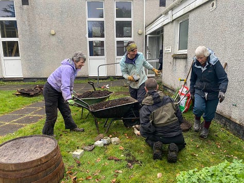 Volunteers working outside the village hall