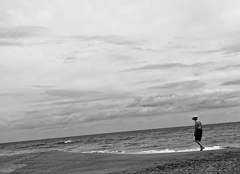 Man in hat walking along the Atlantic OCean beach