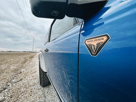 2022 Ford Bronco Badlands details, including side badge, windshield text, rear horse badge, front load points, and side fender flares