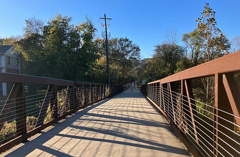 The trail is of consistent width, terrain and layout; grey with a yellow line down the middle
