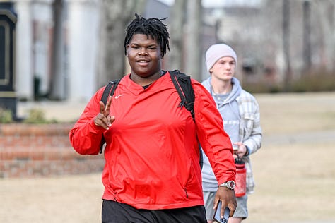 Students walk across the Troy campus heading to class