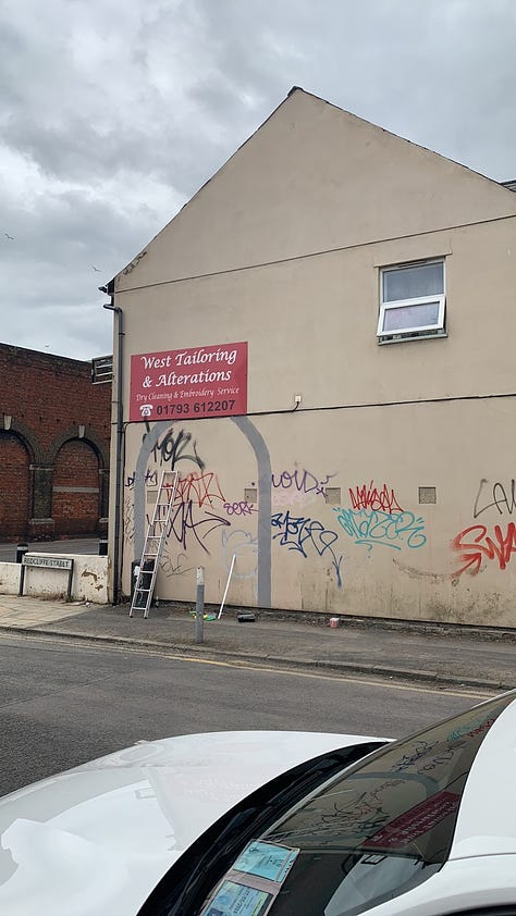 Art mural, artist's painting grey arches.