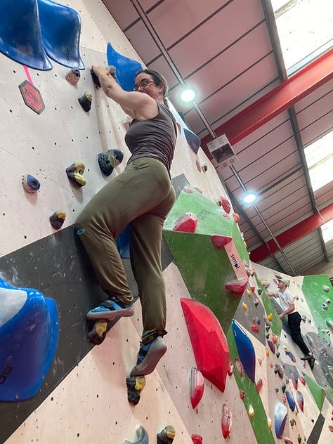 A woman and a boy on a bouldering climbing wall