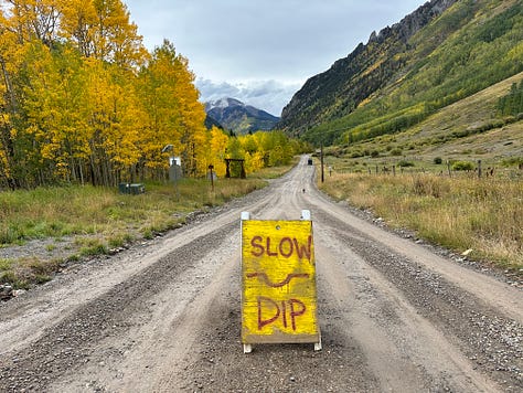 various handmade signs telling you to slow down