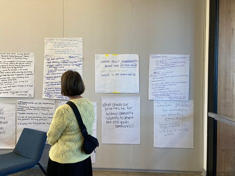 First two photos include Deschutes assembly members deliberating in small groups, and the third photo has a women looking at a wall with priorities that have been written up.