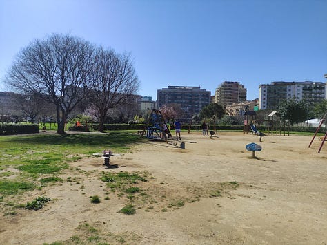 Participants on the route, plus a barren hard-packed surface under the playground