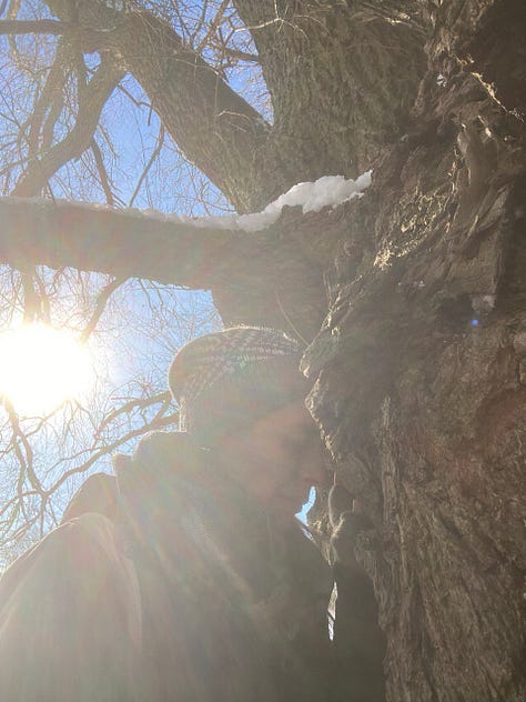 Kath leaning on to the trunk of her beloved Willow tree friend