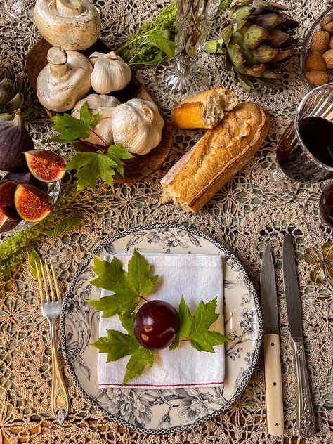 A gallery of creative settings in France. Varying tablescapes at teatime and holiday dinner, pastries and bonbons with pink flowers, watercolor paints, French bread and cheese with an inspiring book