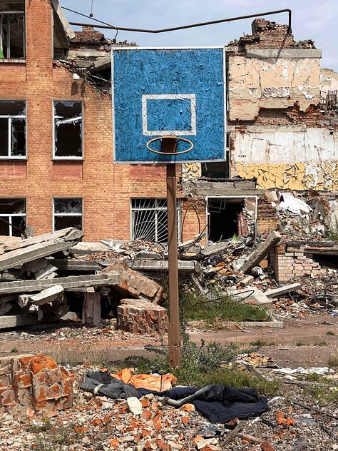 Destroyed residential buildings and school in Chernihiv; Bullet holes in a bust of Taras Shevchenko at Borodyanka; a Russian tank graveyard north of Kyiv; and village scene at Yahidne.