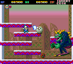 A series of screenshots from the arcade version of Snow Bros. The first depicts the blue face characters you need to defeat in order to spell out "snow" and earn an extra life. They're on screen with a number of standard foes. The second screenshot shows an encounter against the game's first boss, which is a massive lizard-y man who summons smaller enemies to defeat you, which you then turn into snowballs and fire off at him. The third shows the power-up that massively increases your size, as that version of the character flies right into an enemy for a much higher point total than normally defeating them would grant.