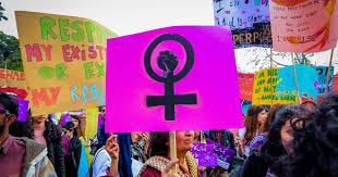 Colourful images of women from Pacific, India, Africa and the US at women's right protests with banners and placards featuring the women's sign as well as badges, singlets and posters with the same symbol. 