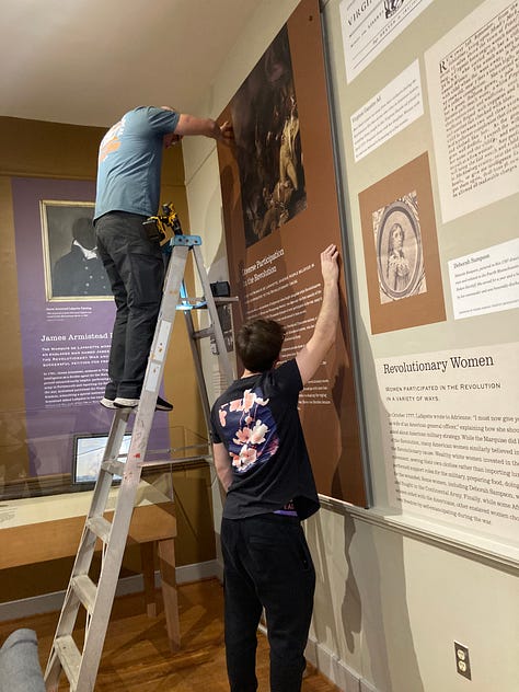 The team from Evolution Printing installs text panels for FAM's exhibit "Lafayette's World: Revolutionary Ideals and the Limits of Freedom" on February 26. The exhibit opens on Friday, March 1.