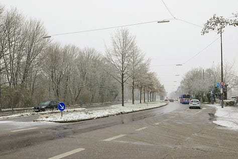 Snowy photos showing paths through an old cemetery and a wide, hostile looking ring road.