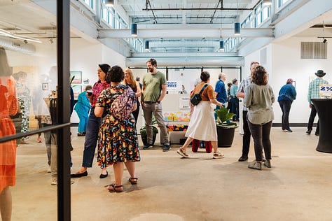 A series of images showing a brightly lit gallery interior with a concrete floor and high ceilings. Various people are gathered around podiums and a colorfully-painted park bench. It is inviting and spacious, with framed artworks on the walls, green broad leaf plants and a few easels displaying signage about the work. 