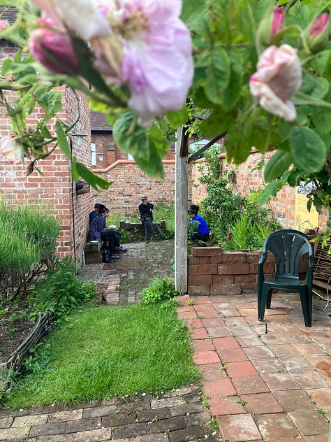 Participants spending time in the Weaver's workshop garden after the diagramming exercise