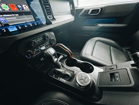 2022 ford bronco badlands interior details including door panels, switches, and digital gauge panels