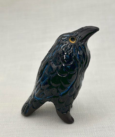 an assortment of weird little bird sculptures, including funky owls, tiny ravens, and wee harpies
