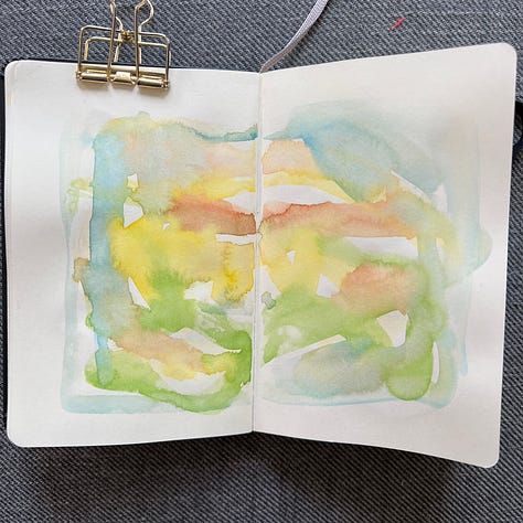 Different pages in a small sketchbook painted with light washes of watercolor in a variety colors