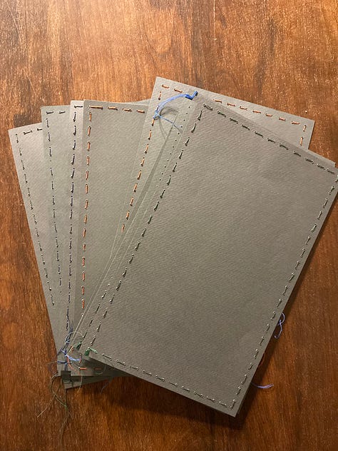 letterpress print project, small artworks with ink on paper, and paper sewn into envelopes.
