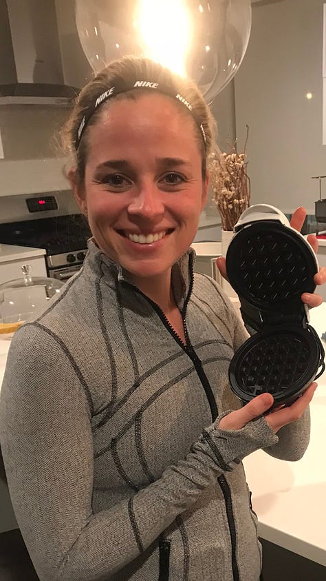 The first image shows Emily holding a tiny waffle iron in her home kitchen. The second shows her standing next to a huge pallet of boxes with waffles ready to be shipped. And the third shows Emily wearing a white hat that reads "Evergreen" while she stands next to a freezer in a retail store containing bags of her waffles.