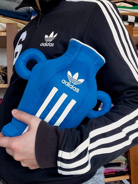1: A lamp made from a red Adidas tracksuit, 2: Jaehun holding a vase made from a blue Adidas tracksuit, 3: A vase made from a blue Adidas tracksuit