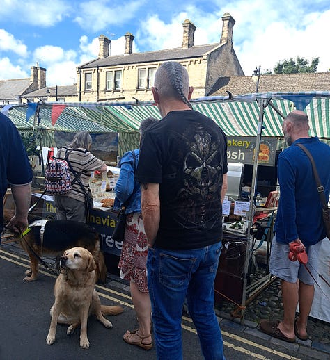 Barnard Castle farmers market; customers, dogs, Town Crier