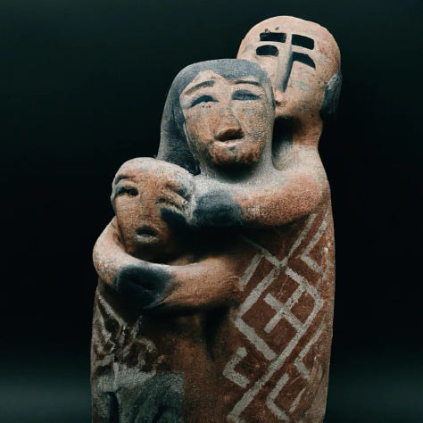 sculptures of people hugging 