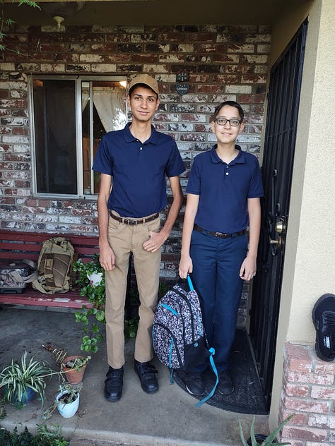 children in school uniform on front porch