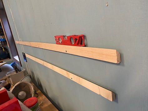 Wall-mounted French cleats to hold my planes and other things.