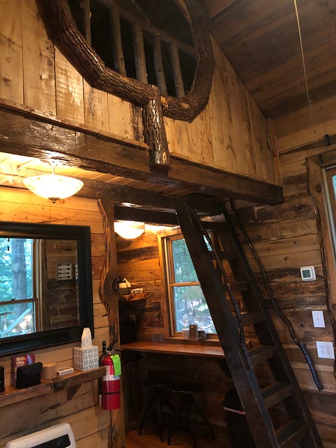 three images: treehouse up in the ari with porch and suspended from two oak trees, a suspension bridge to get there from the top of the stairs, and a view of the inside with a loft bed and kitchen