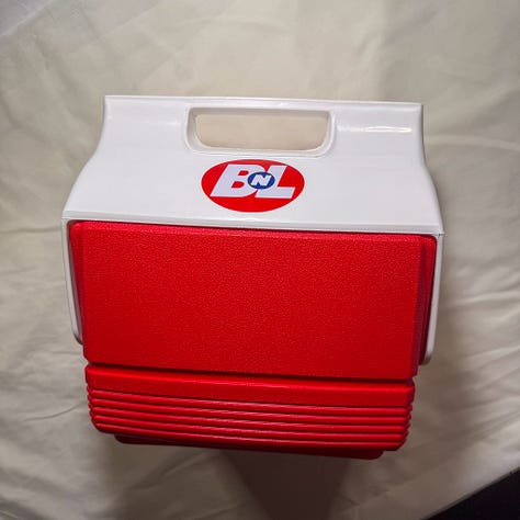 White and red igloo cooler with Buy N Large stickers