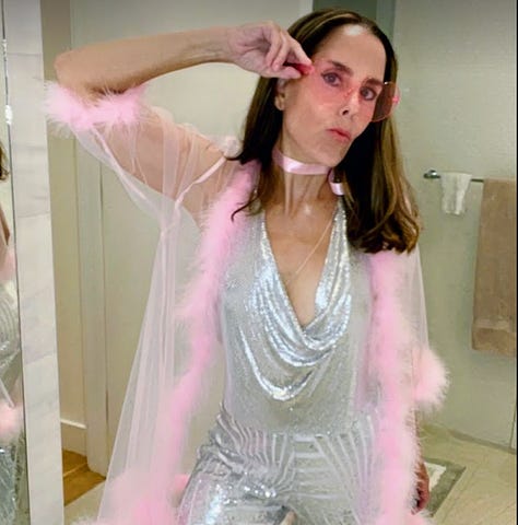 Woman dressed in pink and silver sparkling outfit.