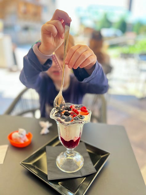 Picture of a girl eating an ice cream on a cone (gelato in Italy), identical twins eating gelato on a cone, and a girl dipping a spoon into a glass cup of yogurt with jam and berries.