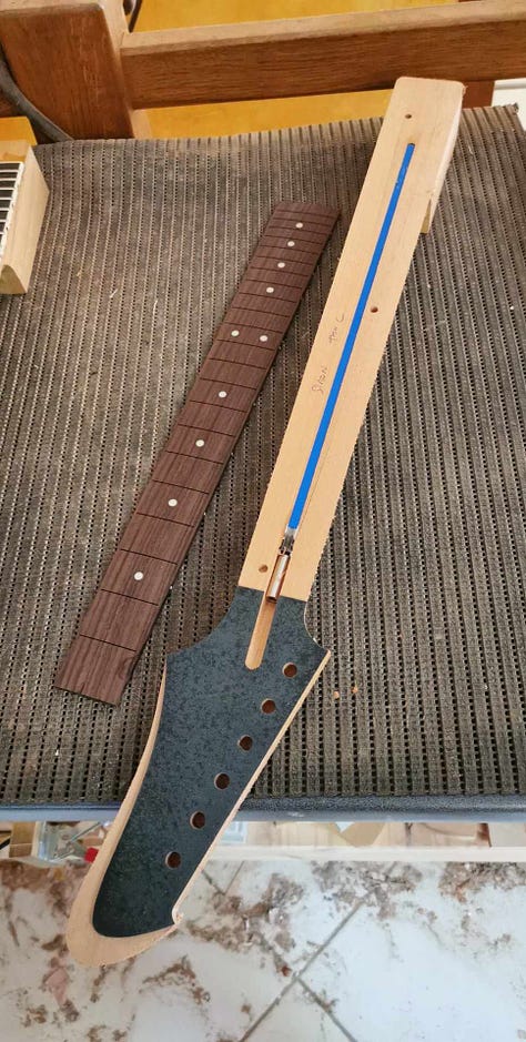 Pictures of the cutout body blank and the neck before and after the fingerboard is glued.
