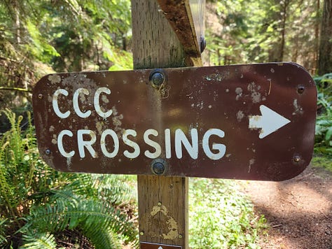 sign for CCC interpretive center, statue of bare-chested CCC worker, sign for CCC crossing