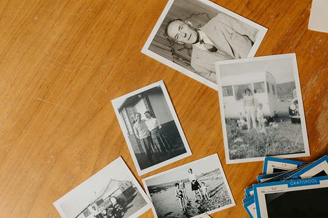 old letters, photographs and slides on a wooden table