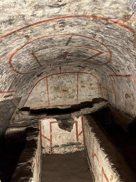 The tomb of Saint Felix adorned with decorations, including an angel, a dove and a fish