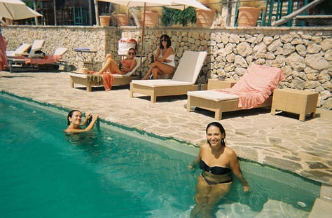 One row of three photos, left to right: Two women wading in the water along the edge of a swimming pool, with two women on shaded lounge chairs in the background, all smiling to camera; Profile of woman sitting on the beach wearing sunglasses, fist to chin, smirking, with a second woman leaning back on her palms on a beach towel on the sand, profiled and gazing out of frame; Four women taking a selfie, smiling wide, in a cityscape with parked cars, a white building, and a palm tree in the background.