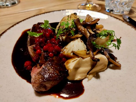 three images of plates of food, one of roasted reindeer, a dessert of cloudberries and a cured fish dish garnished with herbs