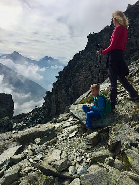 Top L: the road down the Stelvio Pass, cows in a summer Alpine snow storm, wildflowers in Valemalenco, bed stones warming on the fire at a rifugio, spying a stambeco (mountain goat) on a high ridge at 3000m+, skiing in Bormio, snow like thick icing in Madesimo, Alpine peaks and piste Madesimo, me with a hot bedstone to warm my feet 