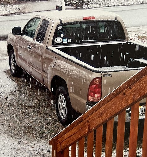 teal Ford Ranger picture from back, tan Tacoma pictured from back while snow is falling, and red-orange Maverick pictured from the front