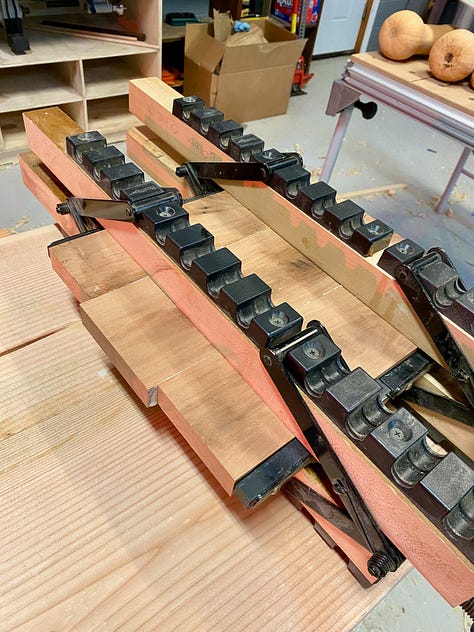 Routing a mortise for the sliding deadman, shown in the second photo. Third image shows three boards being glued together into a larger panel.